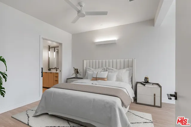 a bedroom with a bed and a mirror