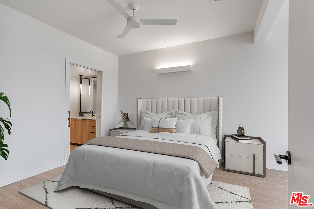 3688 Overland Avenue, Unit PH14 Los Angeles, CA 90034 - Photo 9 of 37 a bedroom with a bed and a mirror