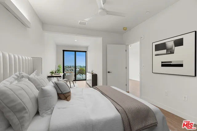 a bedroom with a large bed and a window