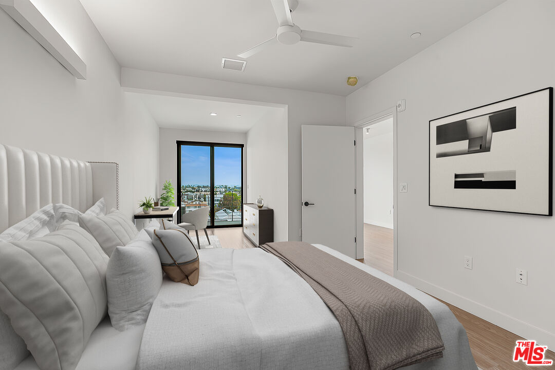 3688 Overland Avenue, Unit PH14 Los Angeles, CA 90034 - Photo 10 of 37 a bedroom with a large bed and a window