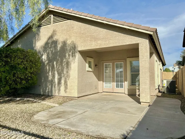 a view of a house with a backyard