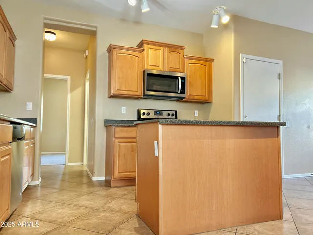 a view of a kitchen with a refrigerator cabinets and a sink