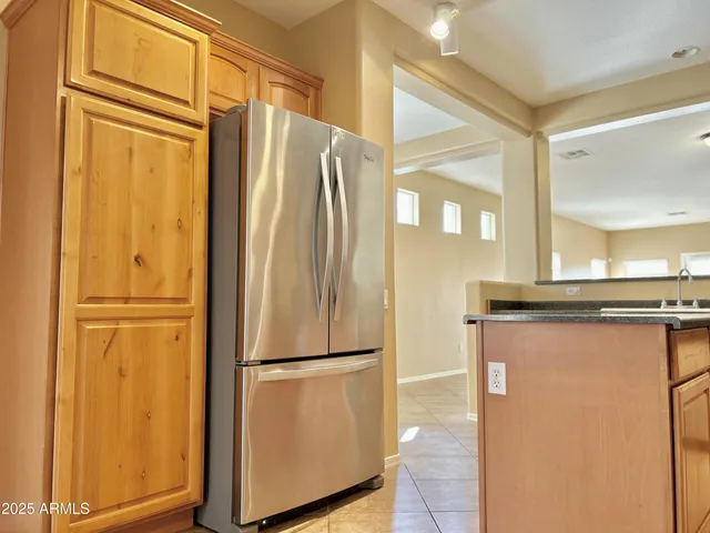 a view of a refrigerator in kitchen and wooden floor