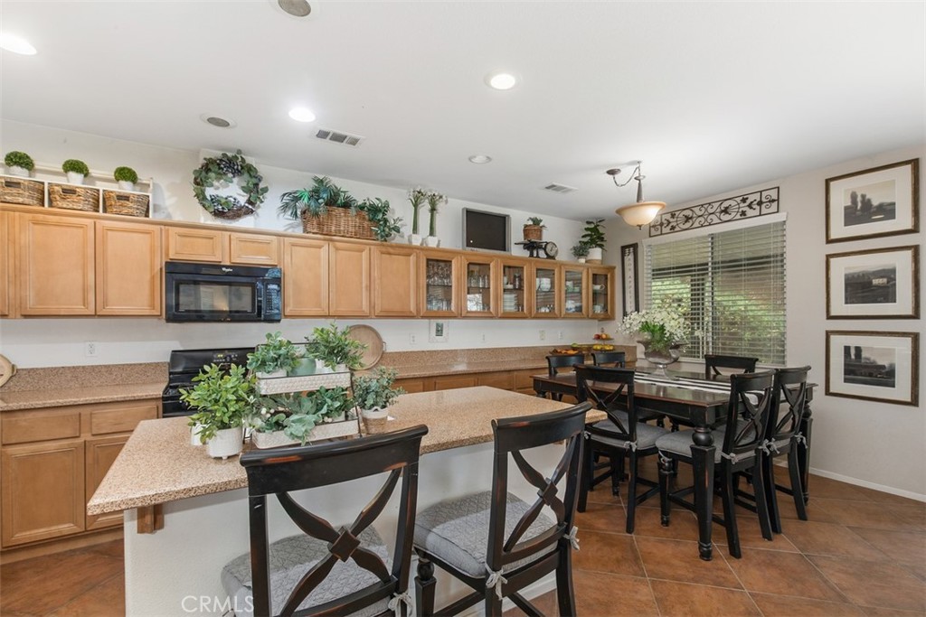 32095 Zion Way Winchester, CA 92596 - Photo 12 of 30 a view of a dining room with furniture and wooden floor