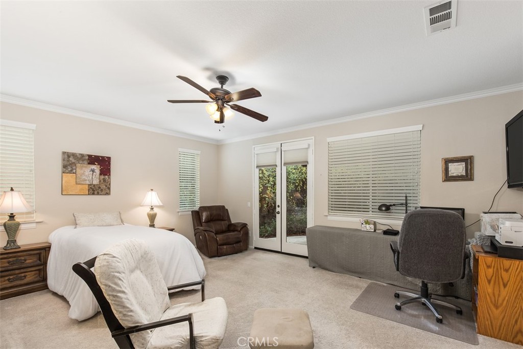 32095 Zion Way Winchester, CA 92596 - Photo 22 of 30 a bedroom with a bed a couch and a chandelier