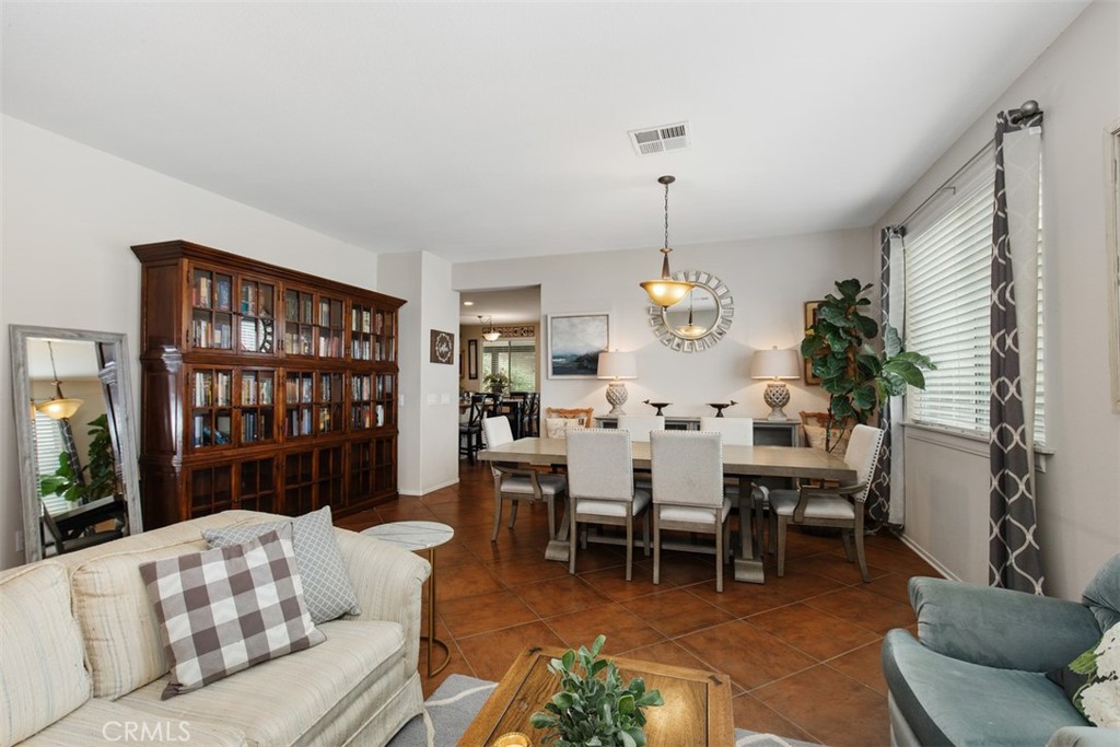 32095 Zion Way Winchester, CA 92596 - Photo 7 of 30 a living room with furniture a chandelier and a dining table