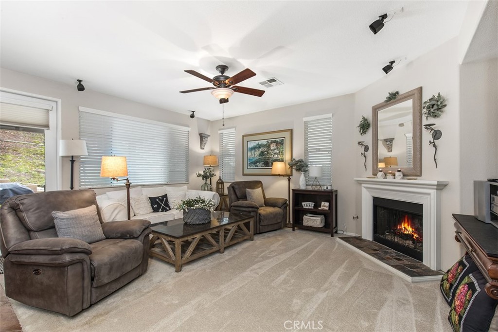 32095 Zion Way Winchester, CA 92596 - Photo 8 of 30 a living room with furniture a fireplace and a flat screen tv