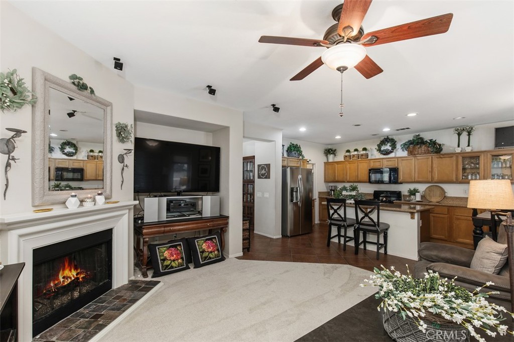 32095 Zion Way Winchester, CA 92596 - Photo 9 of 30 a living room with furniture a flat screen tv and a fireplace