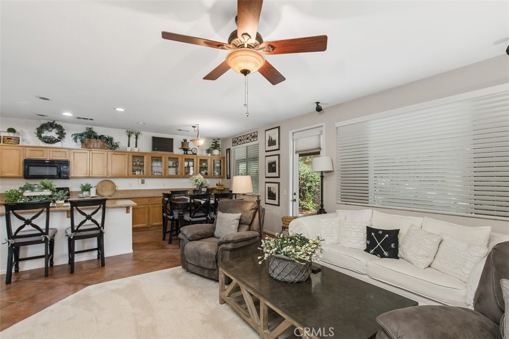 32095 Zion Way Winchester, CA 92596 - Photo 10 of 30 a living room with furniture kitchen view and a large window