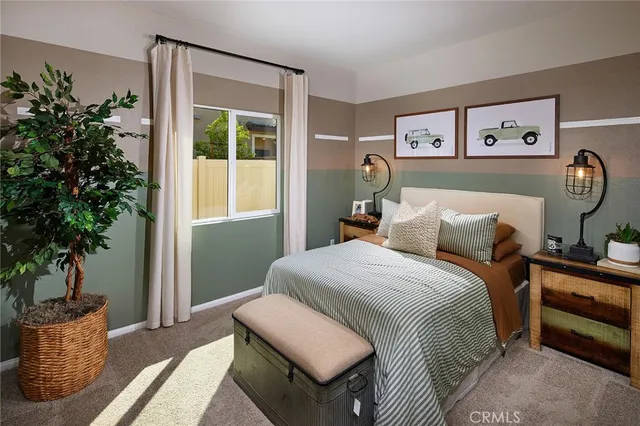 a bedroom with a bed and a potted plant
