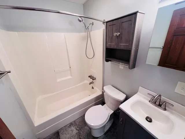 a bathroom with a toilet sink and shower