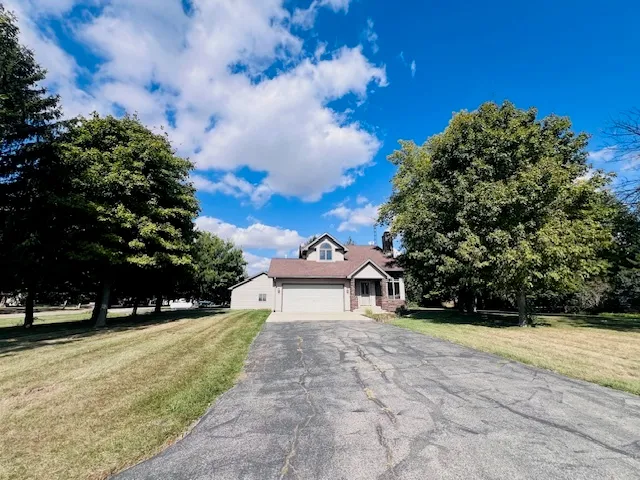 a view of a white house with a yard