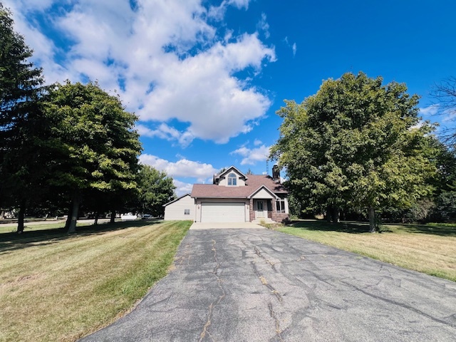 7705 Lakewood Road Weldon, IL 61882 - Photo 33 of 40 a view of a white house with a yard