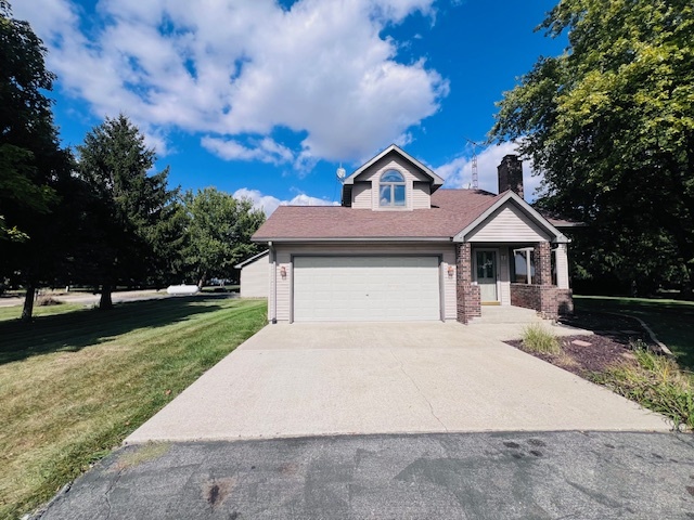 7705 Lakewood Road Weldon, IL 61882 - Photo 34 of 40 a front view of a house with a yard and garage