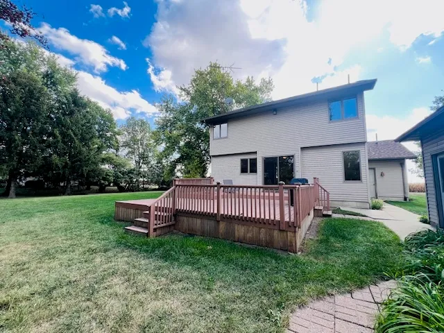 a view of a house with a yard and deck