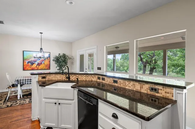 a kitchen with stainless steel appliances granite countertop a sink and a stove