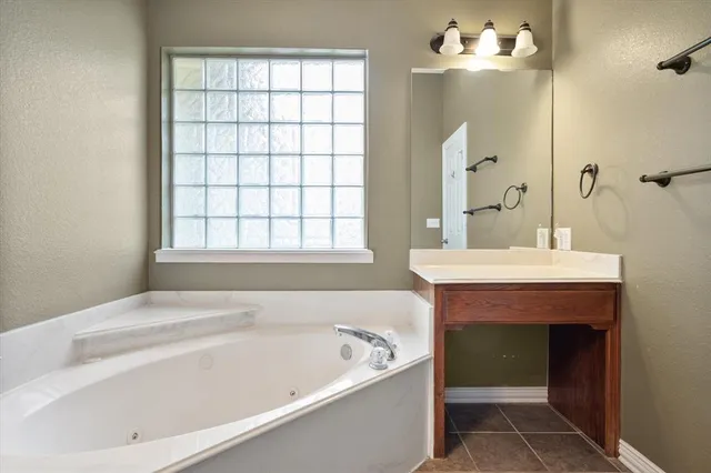 a bathroom with a bathtub and a sink