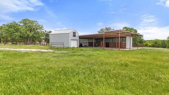 a view of a house with a yard and sitting area