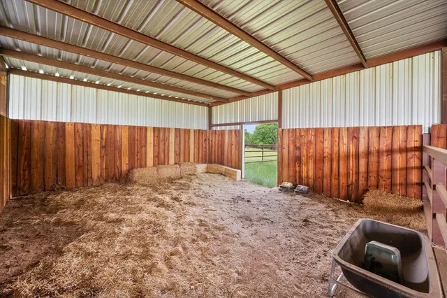 a view of a backyard with wooden fence