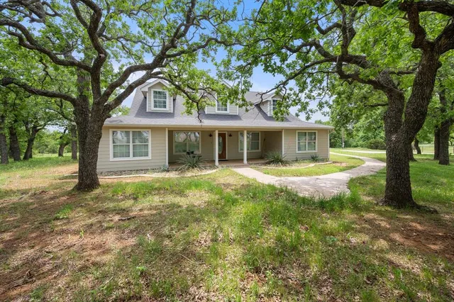 a view of house with a yard