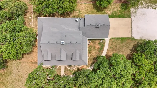an aerial view of a house with a yard