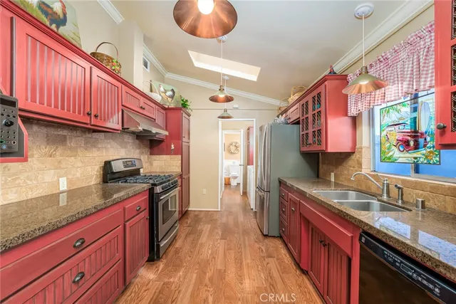 a kitchen with stainless steel appliances granite countertop a sink stove and cabinets