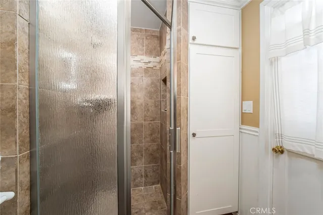 a bathroom with a glass shower door