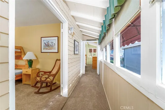 a view of a hallway with a livingroom and a dinning area