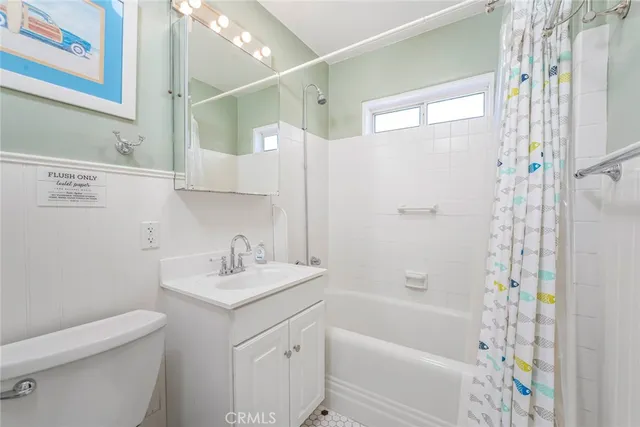 a bathroom with a sink toilet vanity and shower