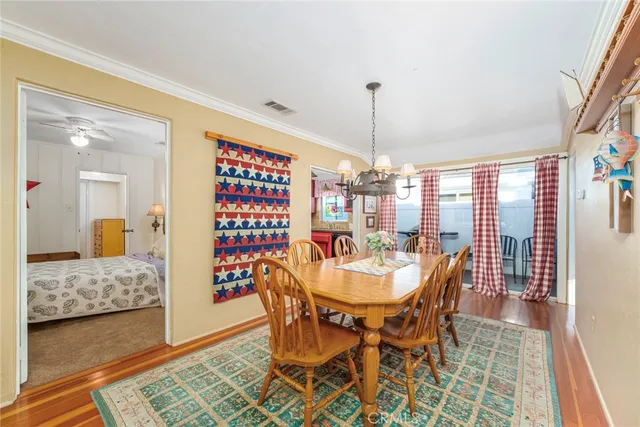 a view of a dining room with furniture and chandelier