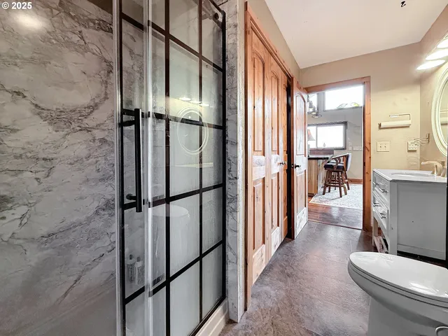 a bathroom with a toilet a sink and a large mirror