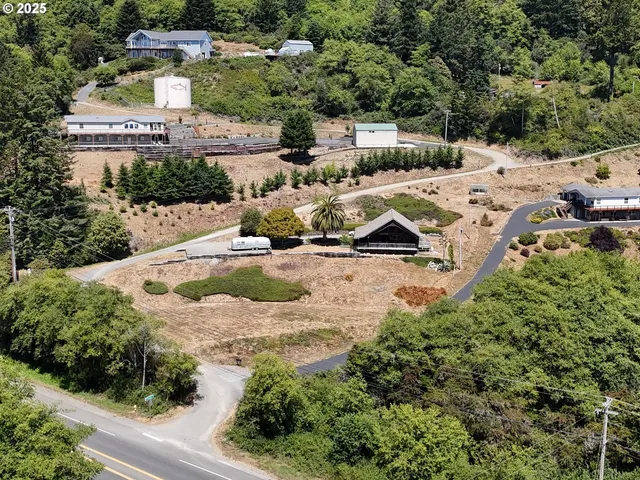 an aerial view of a house with yard swimming pool and lake view