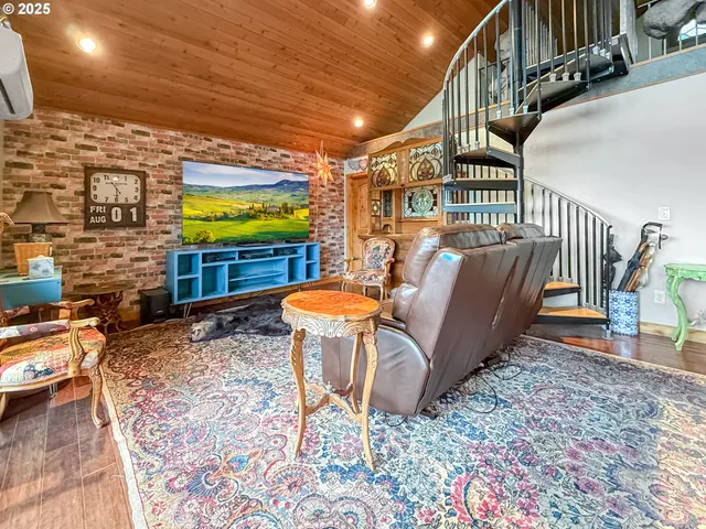 a chairs and table in a hall with wooden floor