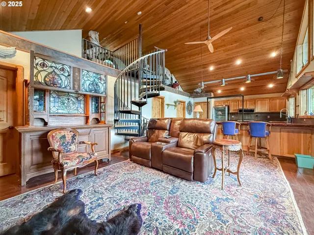 a living room with furniture a rug and a chandelier