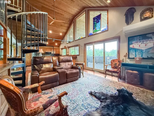a living room with furniture a rug and a large window