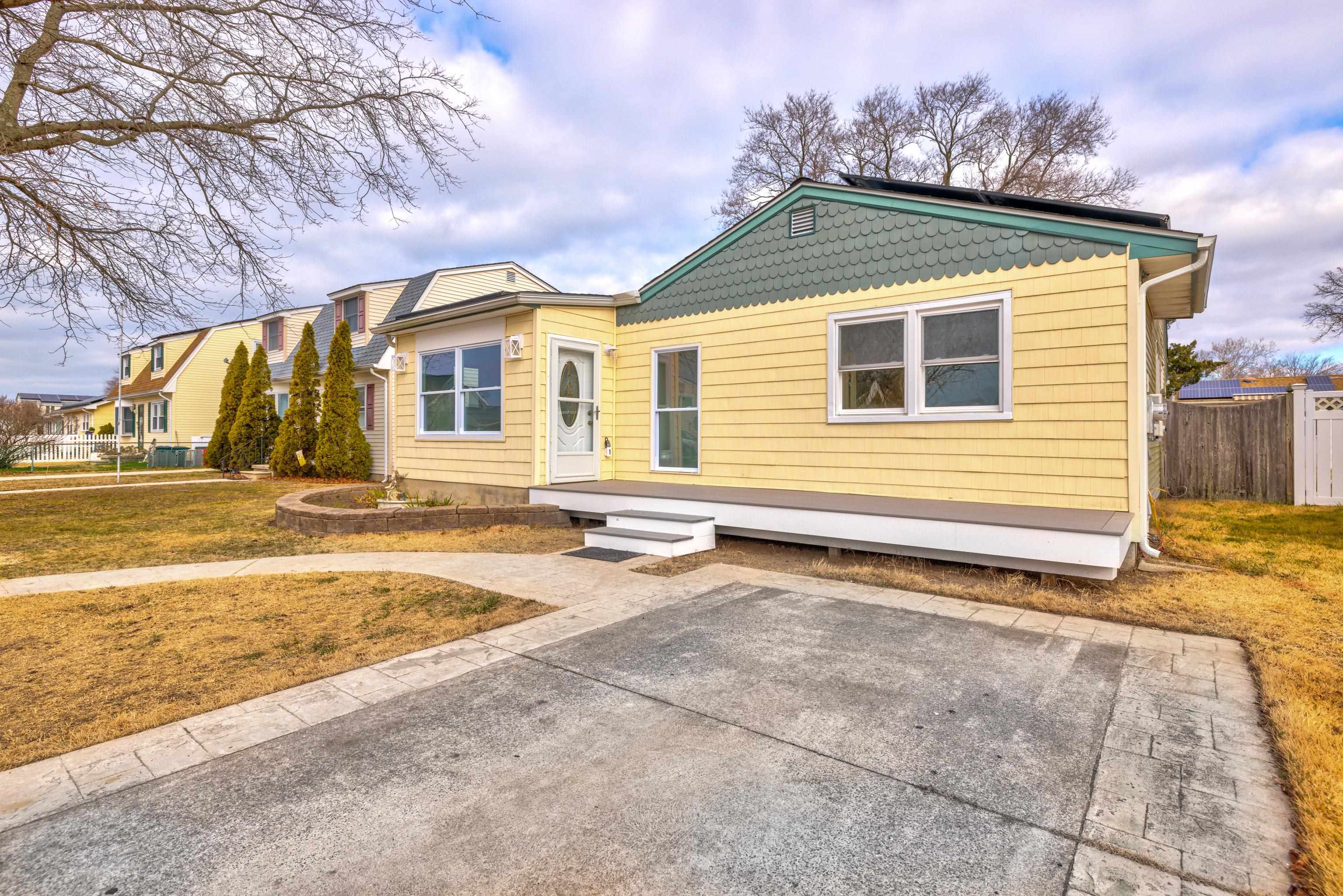 121 Broadway Villas, NJ 08251 - Photo 1 of 32 a front view of a house with a yard