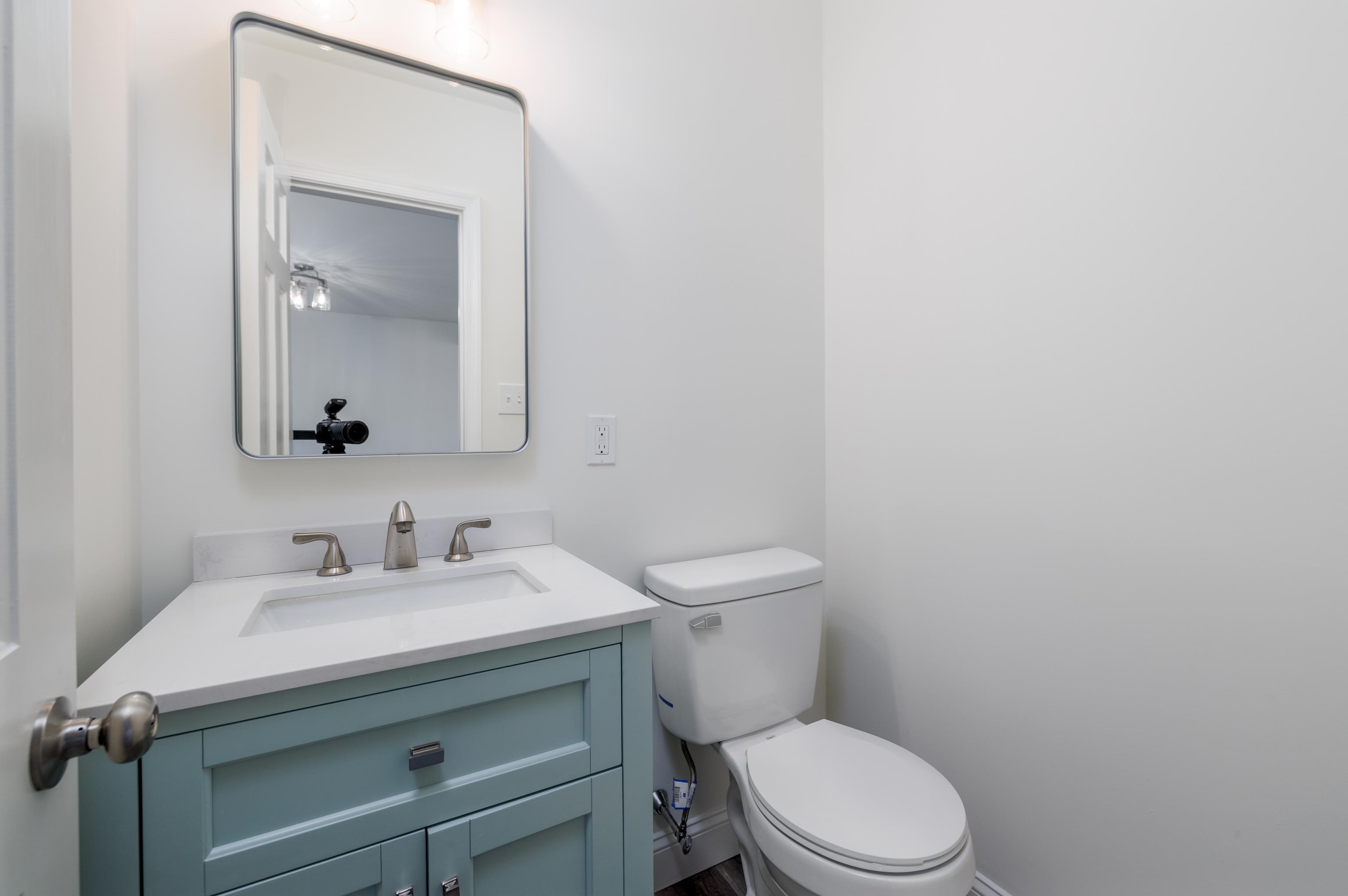 121 Broadway Villas, NJ 08251 - Photo 11 of 32 a bathroom with a toilet sink vanity and mirror