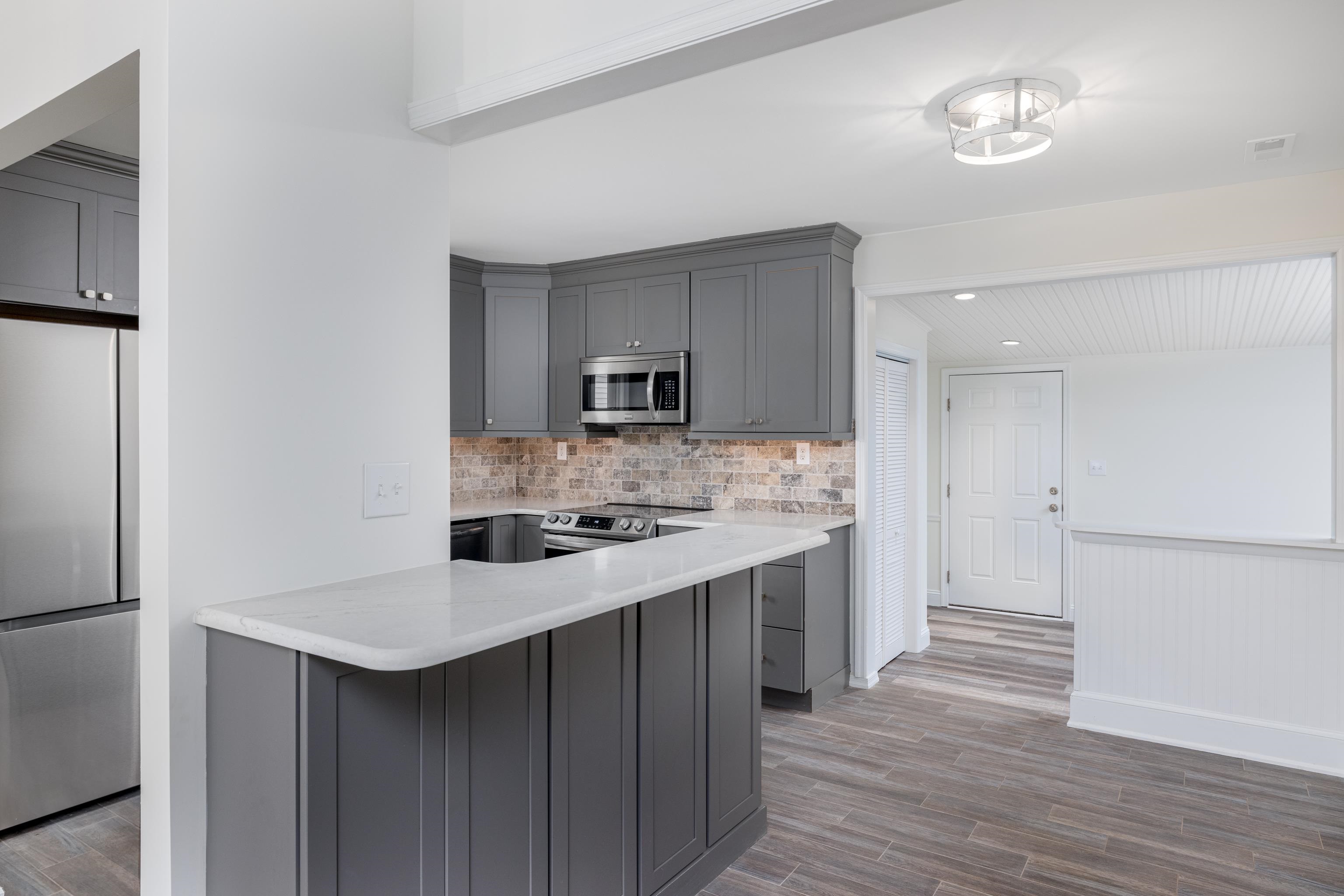 121 Broadway Villas, NJ 08251 - Photo 12 of 32 a kitchen with a sink a stove a refrigerator and white cabinets