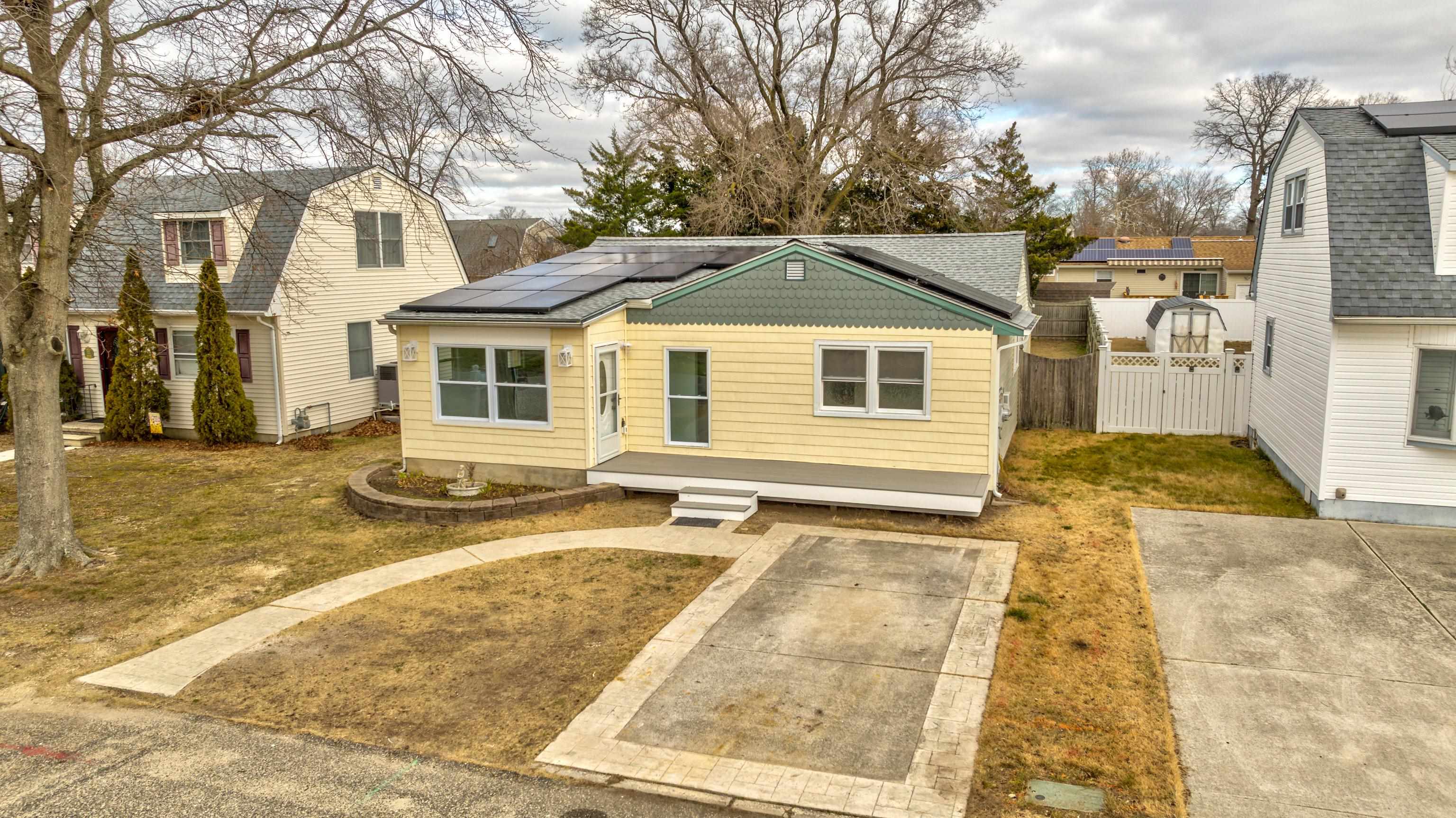 121 Broadway Villas, NJ 08251 - Photo 2 of 32 a view of a white house with a large tree