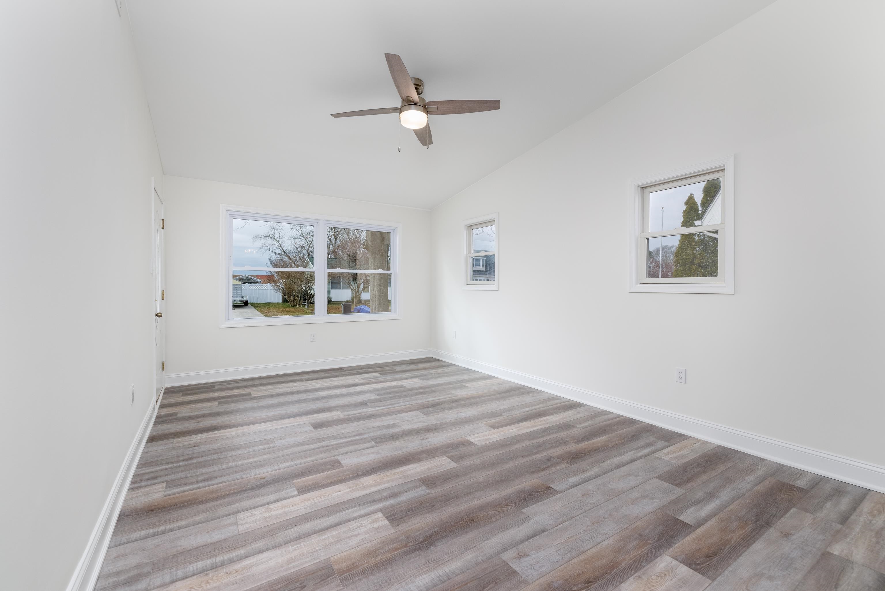 121 Broadway Villas, NJ 08251 - Photo 8 of 32 a view of empty room with wooden floor and fan
