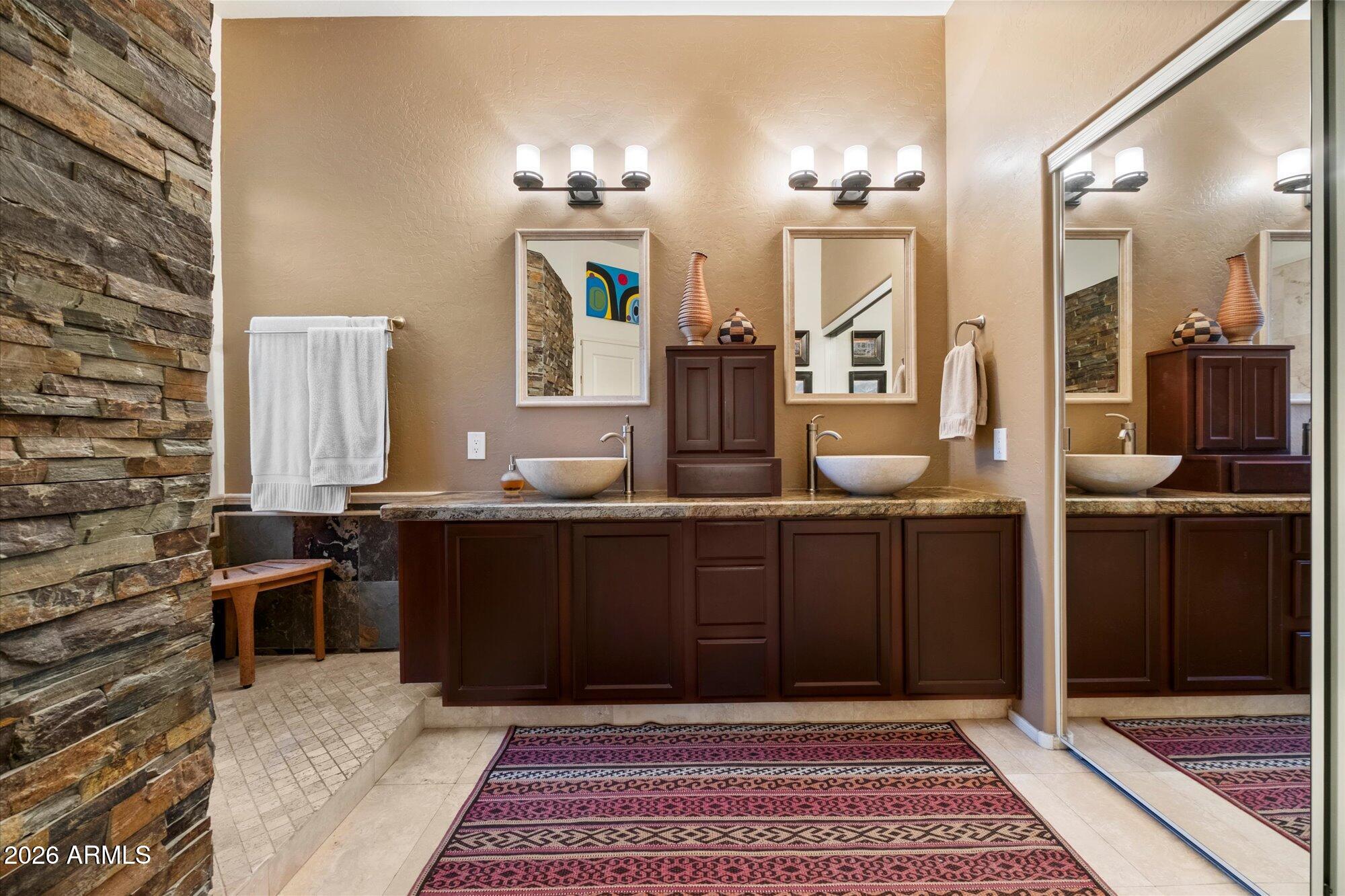 5025 East Kirkland Road Phoenix, AZ 85054 - Photo 23 of 37 a bathroom with a sink and a mirror