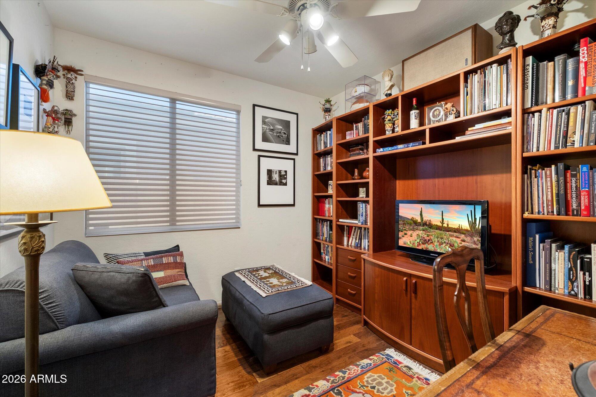 5025 East Kirkland Road Phoenix, AZ 85054 - Photo 25 of 37 a living room with furniture and a book shelf