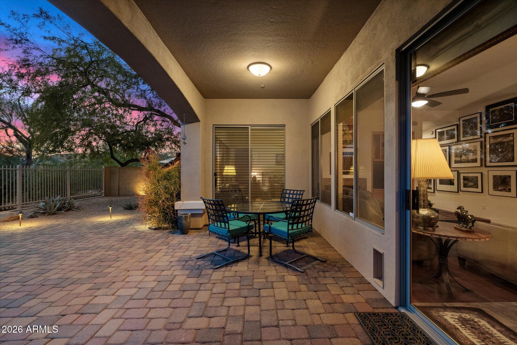 5025 East Kirkland Road Phoenix, AZ 85054 - Photo 27 of 37 a view of a patio with table and chairs potted plants and floor to ceiling window