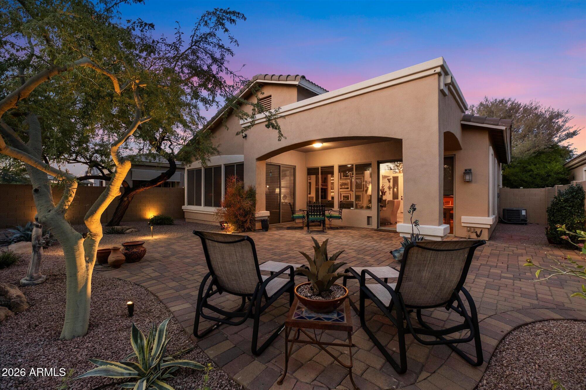 5025 East Kirkland Road Phoenix, AZ 85054 - Photo 7 of 37 a view of a patio with a table and chairs under an umbrella