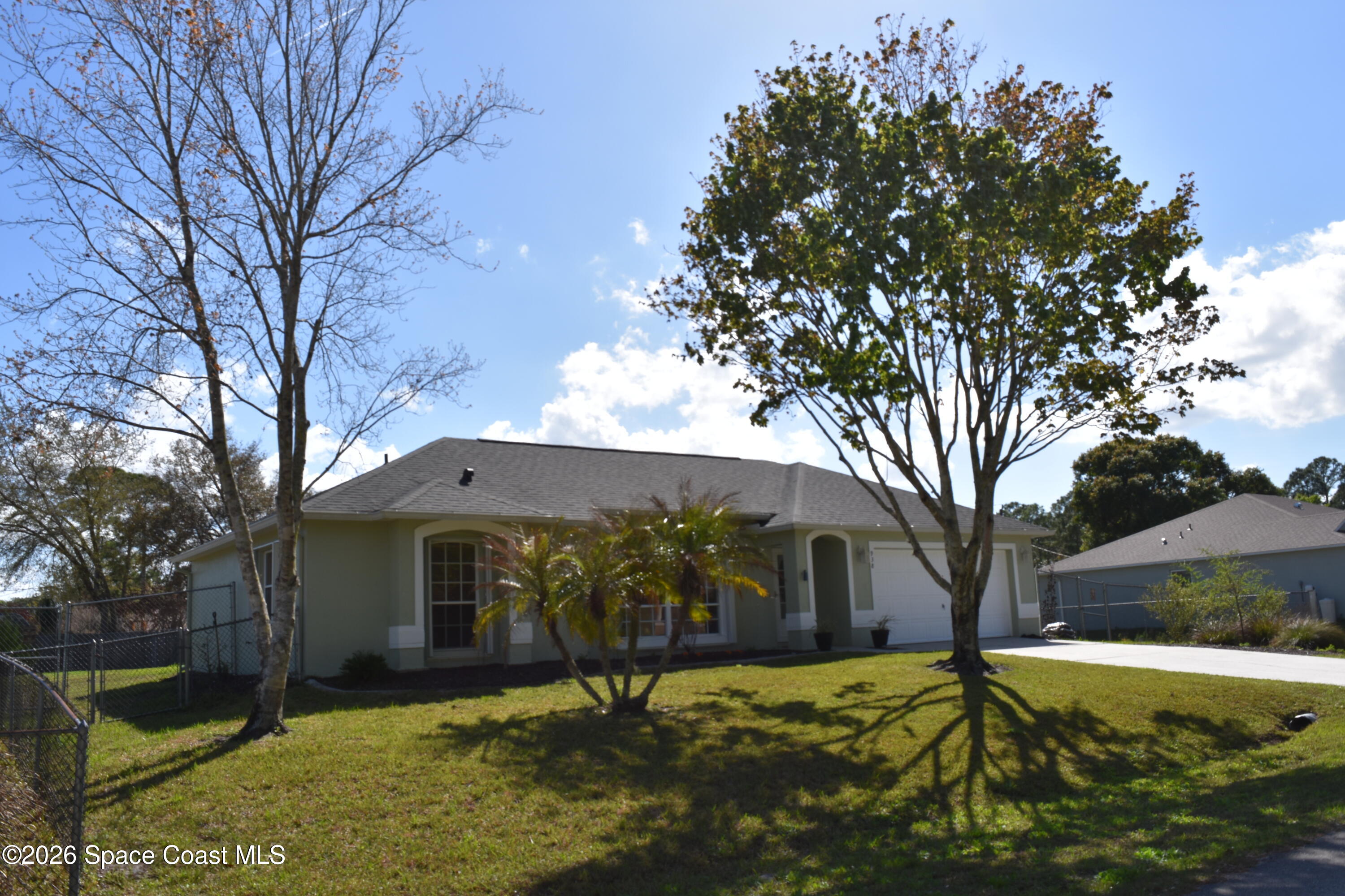 938 Commerce Road Southeast Palm Bay, FL 32909 - Photo 1 of 31 a view of a yard with a tree