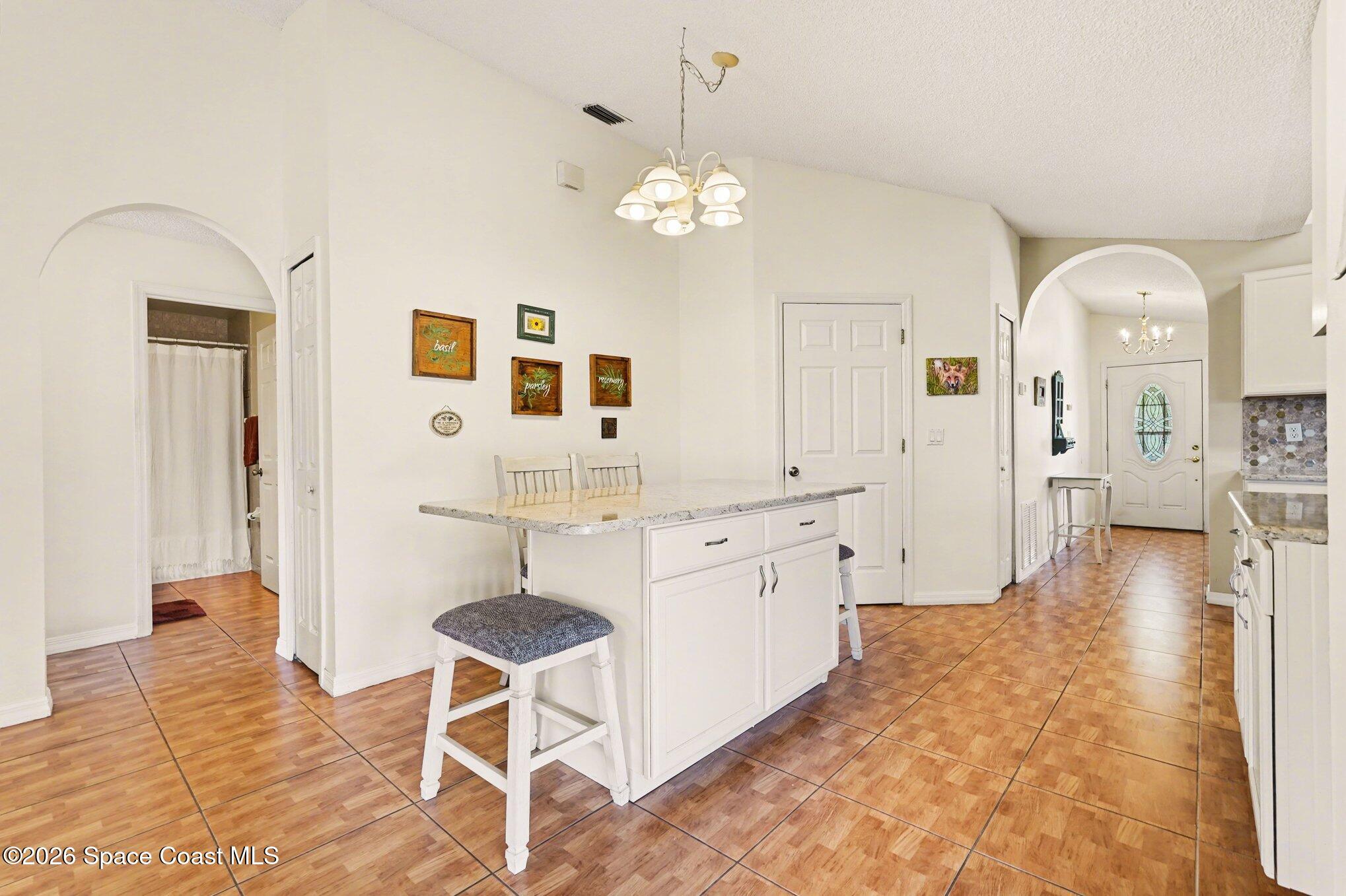 938 Commerce Road Southeast Palm Bay, FL 32909 - Photo 12 of 31 a spacious bathroom with a granite countertop sink a mirror and a shower
