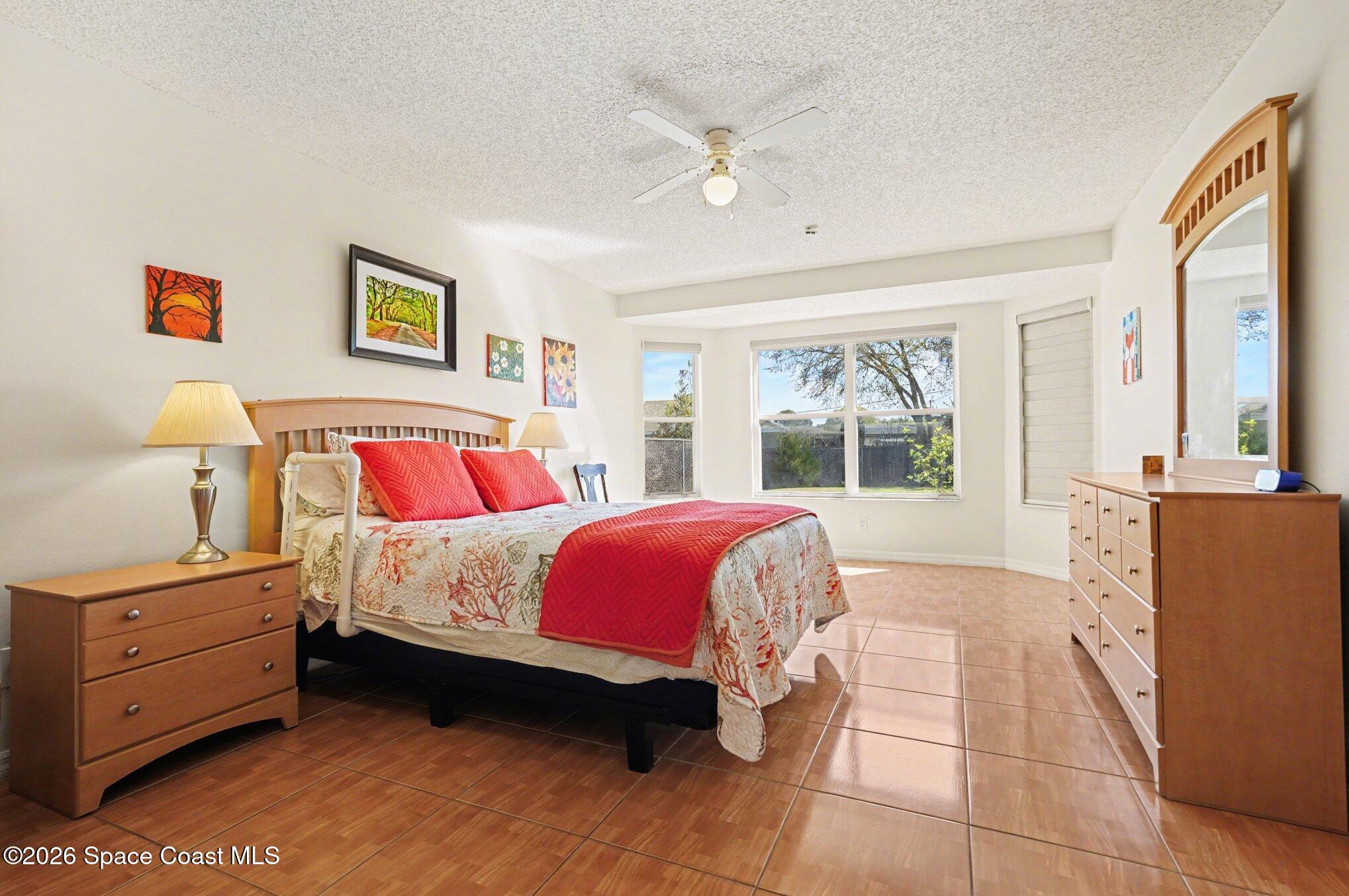 938 Commerce Road Southeast Palm Bay, FL 32909 - Photo 18 of 31 a bed room with a bed and a window
