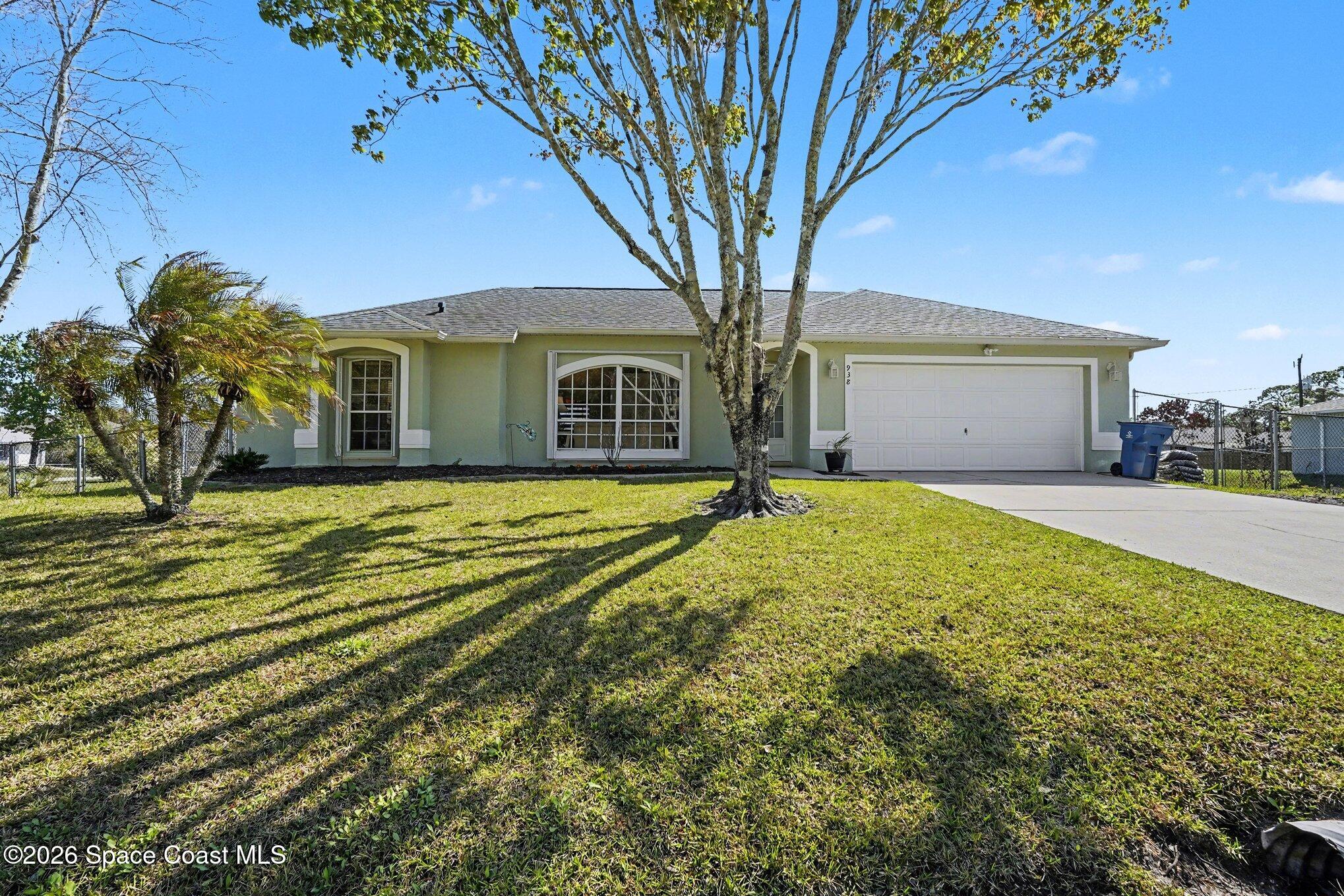 938 Commerce Road Southeast Palm Bay, FL 32909 - Photo 2 of 31 a view of a house with a yard