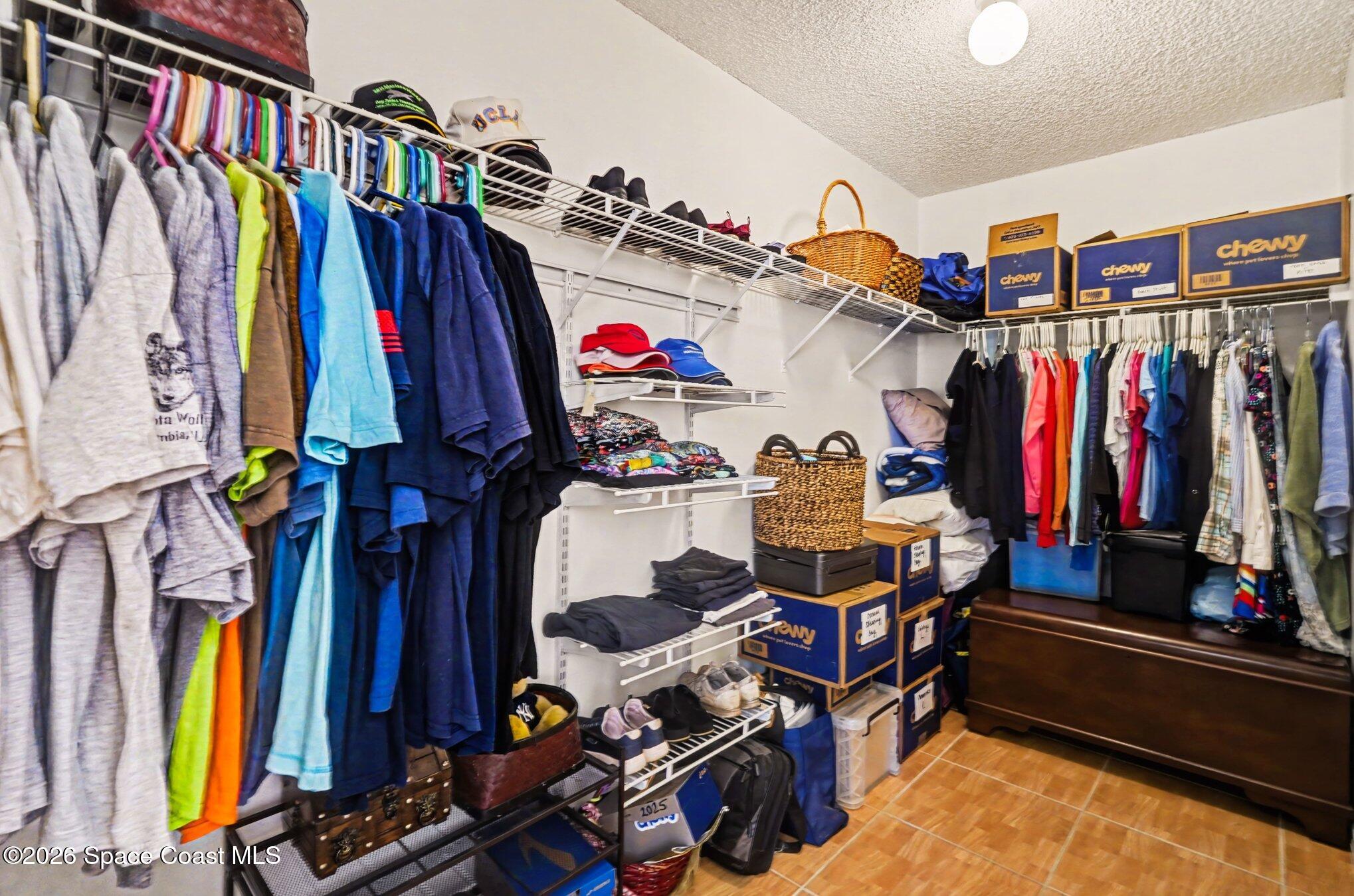 938 Commerce Road Southeast Palm Bay, FL 32909 - Photo 21 of 31 a view of walk in closet with clothes and shoes