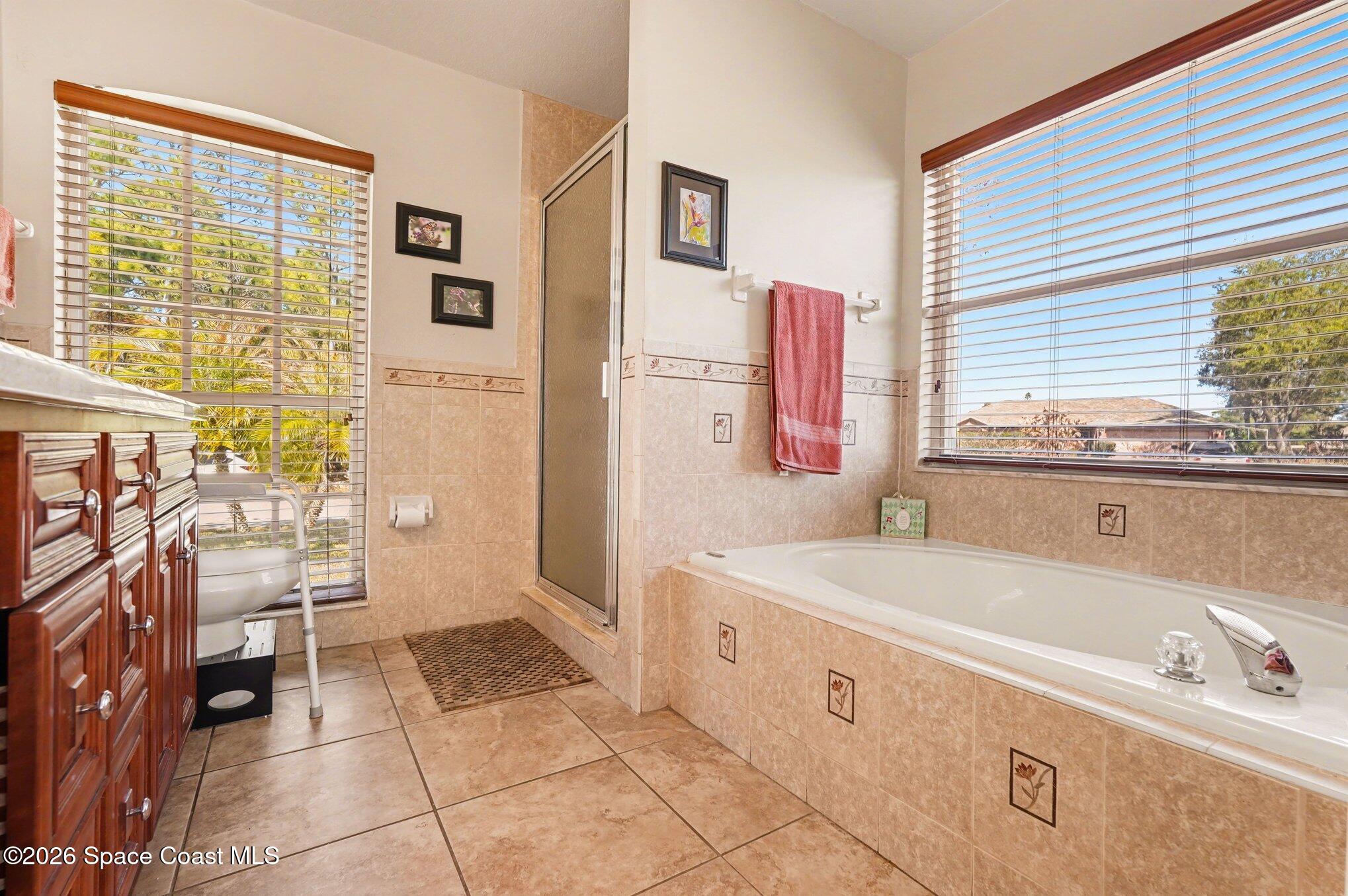 938 Commerce Road Southeast Palm Bay, FL 32909 - Photo 23 of 31 a spacious bathroom with a tub sink and a mirror